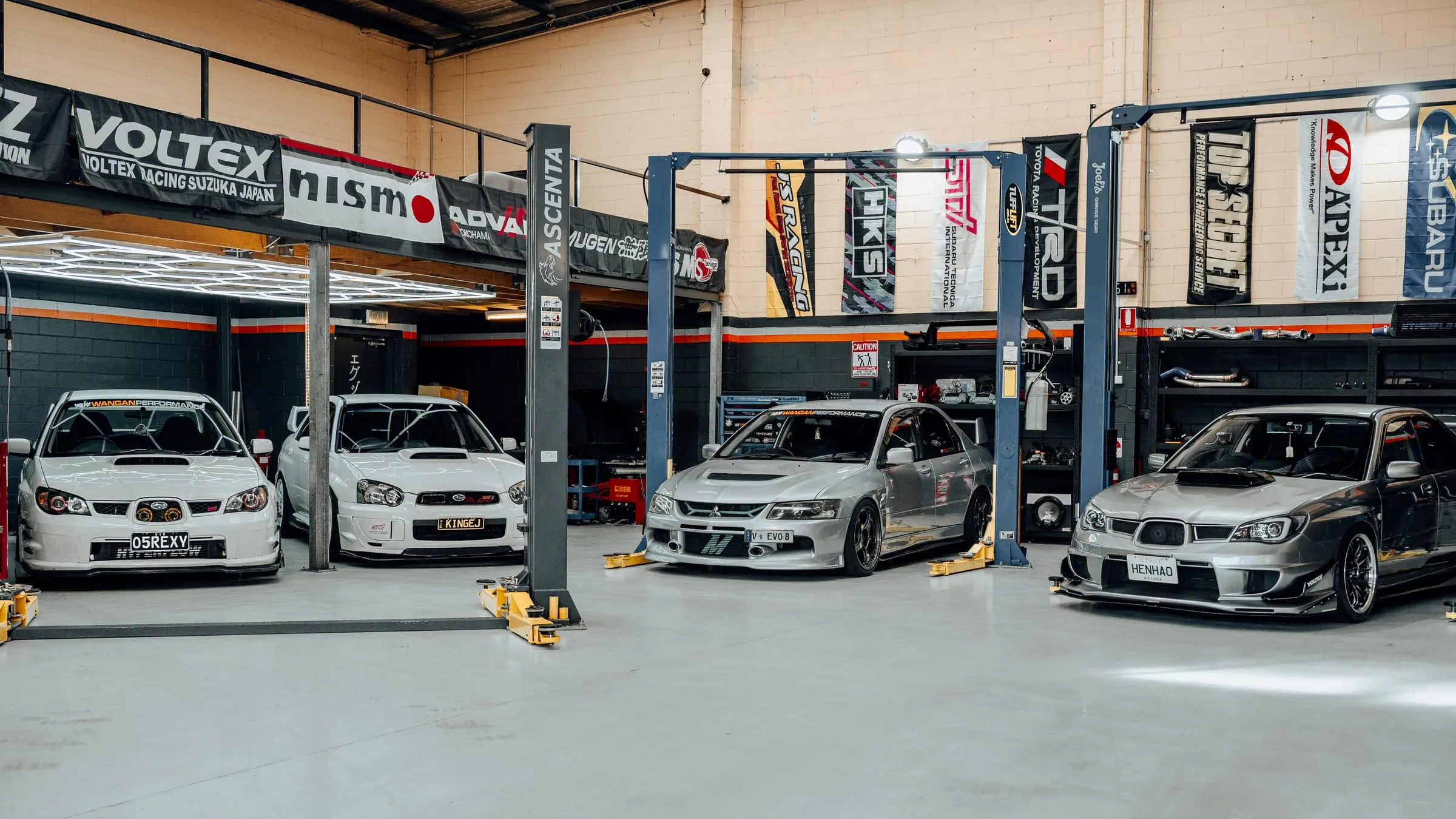 JDM cars on hoists inside the Wangan Performance workshop in Oakleigh South